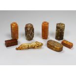 Eight Chinese archaistic jade or hardstone pendants/beads with carved decoration, the largest 9cm