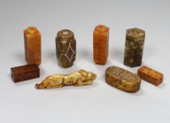 Eight Chinese archaistic jade or hardstone pendants/beads with carved decoration, the largest 9cm