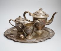 A Thai white metal five piece coffee service, decorated with figures and elephants, tray 31cmCITES