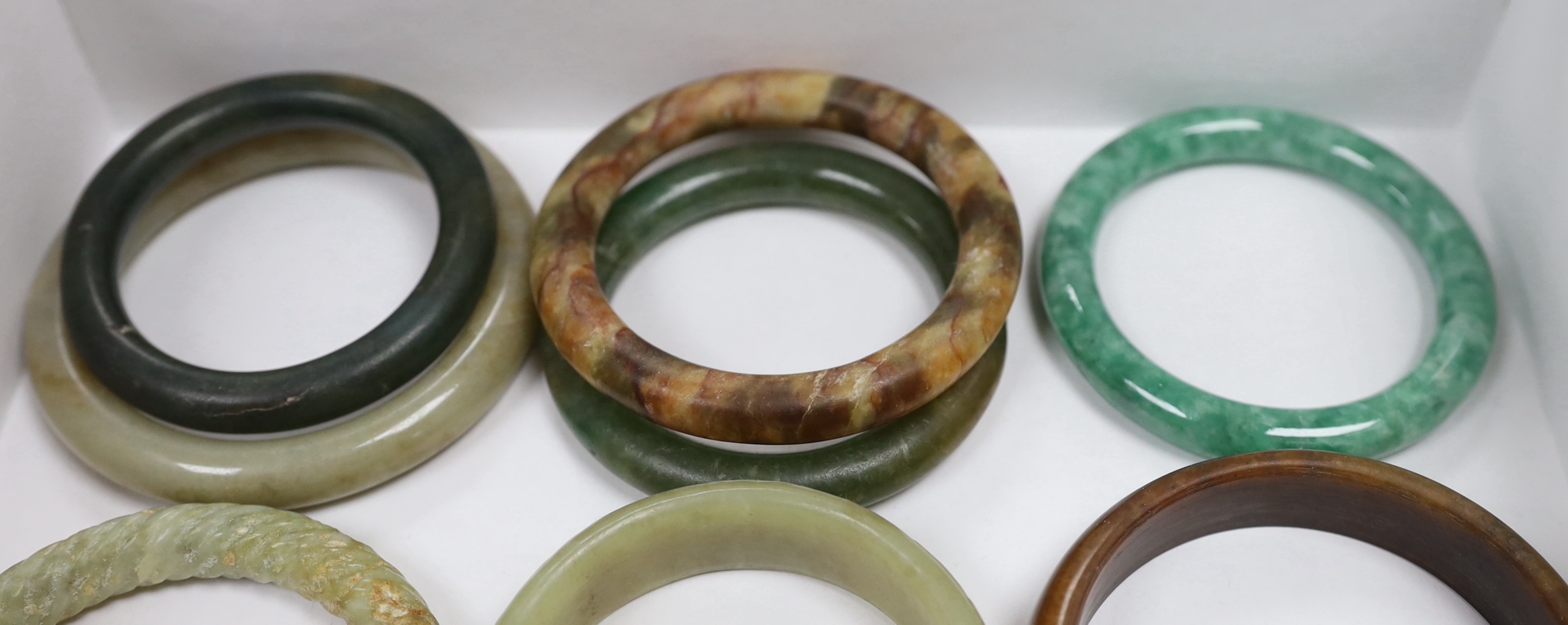 Eleven Chinese jade or hardstone bangles, largest 9cm - Image 2 of 4