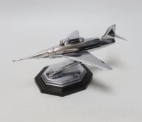 A chrome novelty table lighter in the form of a jet aircraft raised on an octagonal base, 24cm wide
