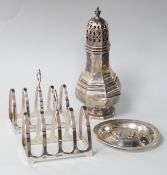 A George V octagonal silver caster, Sheffield 1932, 121 grams, a pair of Walker & Hall toast
