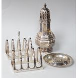 A George V octagonal silver caster, Sheffield 1932, 121 grams, a pair of Walker & Hall toast