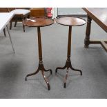 A pair of reproduction circular mahogany tripod torcheres, diameter 34cm, height 80cm