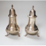 A near pair of George VI silver casters, with baluster bodies and pad feet, makers Elkington & Co,