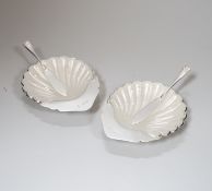 A pair of Elizabeth II silver scallop shell butter dishes, with frosted glass liners, 10cm, nett