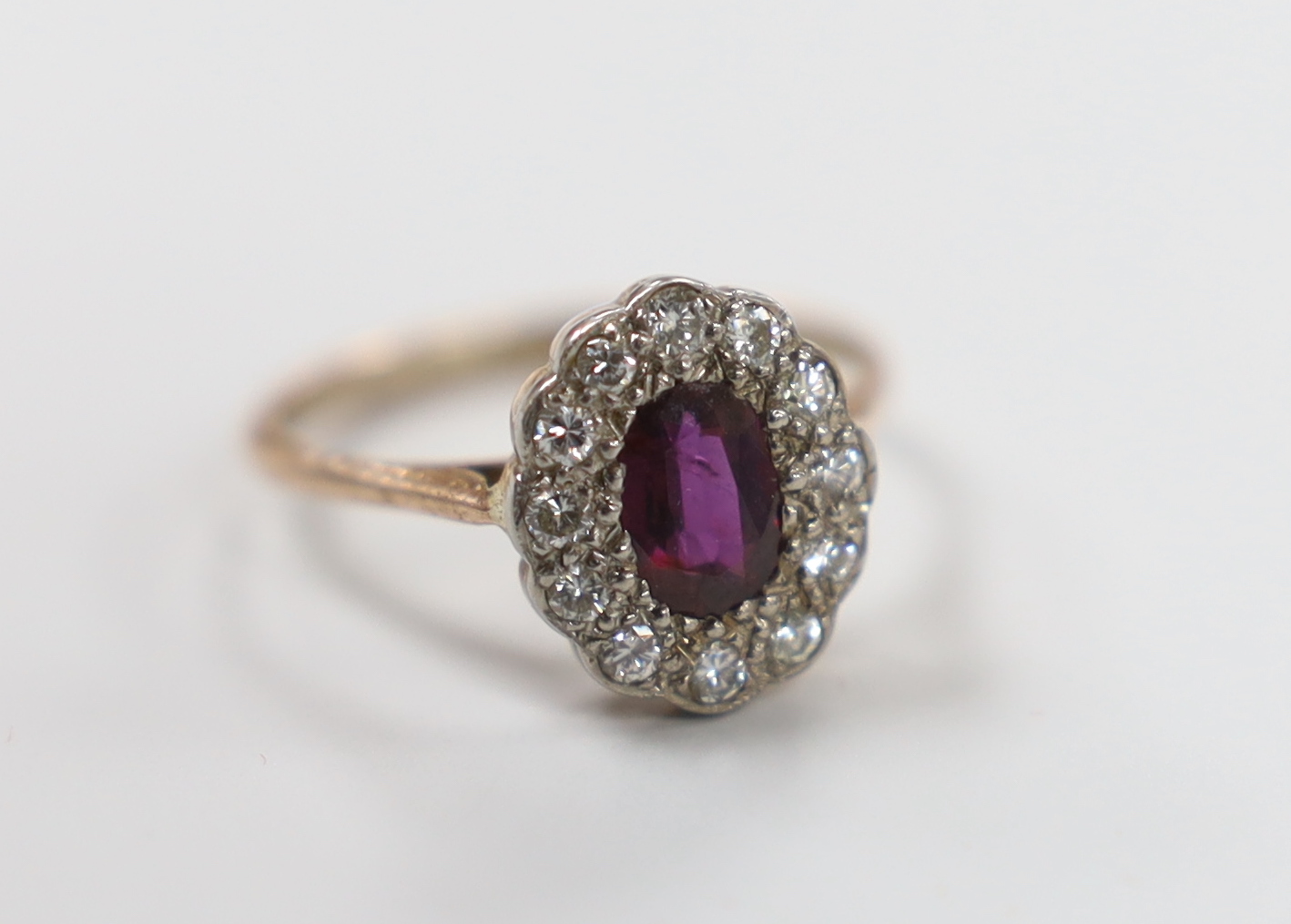 A 9k gold, diamond and garnet cluster ring, size L