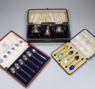 A cased set of six George V silver coffee bean coffee spoons, with enamelled bowls, Birmingham 1933,