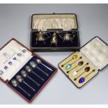 A cased set of six George V silver coffee bean coffee spoons, with enamelled bowls, Birmingham 1933,