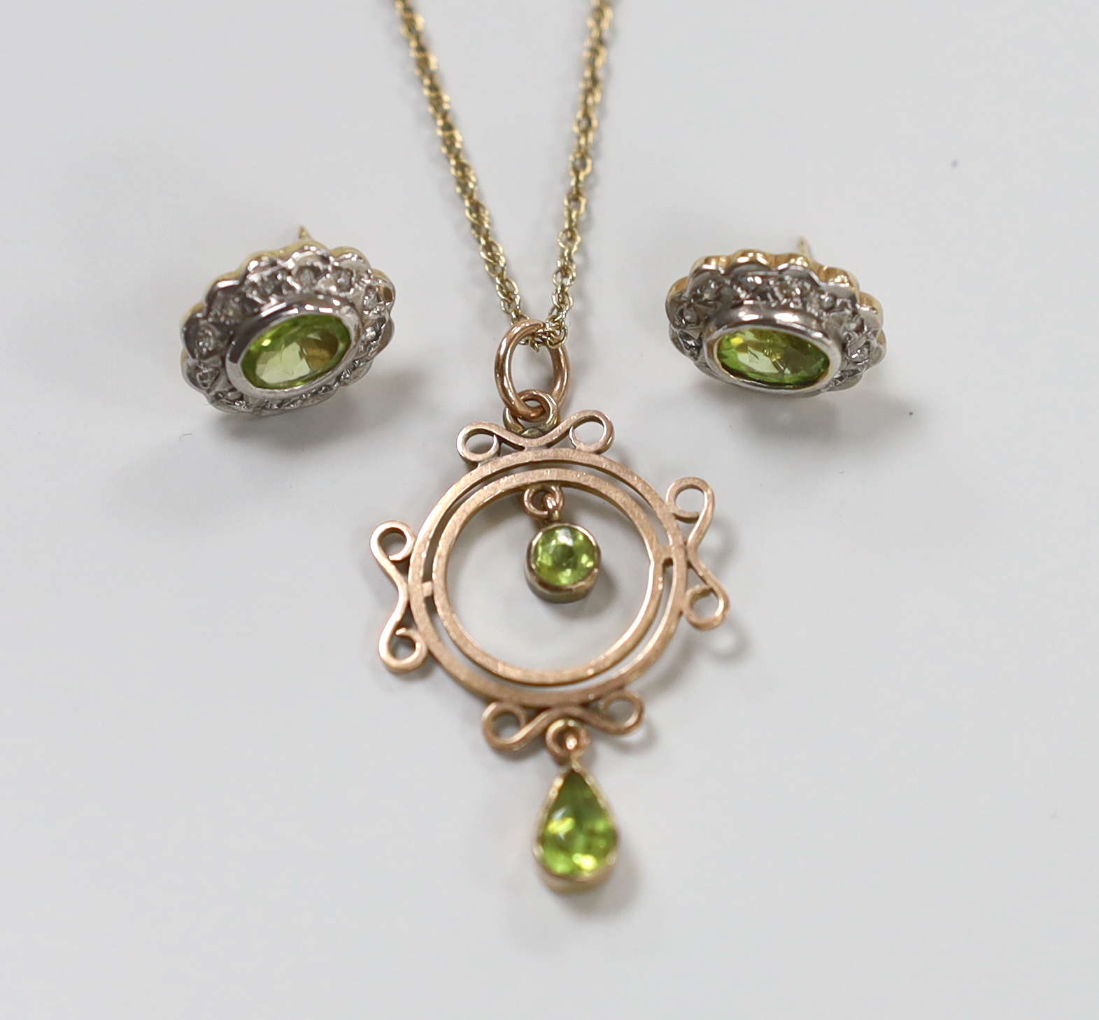 An early 20th century rose gold and peridot pendant necklace, on later chain, gross 3.5 grams and