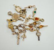 Sixteen assorted 19th century yellow metal overlaid and mainly gem set small watch keys, including