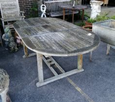 A weathered teak extending garden table, length 211cm extended, depth 110cm, height 75cm