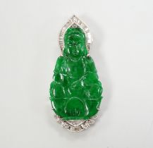 An 18k, baguette and round cut diamond cluster set carved jade figural pendant, the back with