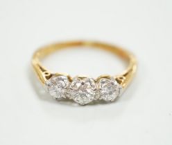 An 18ct, plat and three stone diamond set ring, size K, gross weight 2.7 grams.