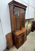 A Victorian serpentine mahogany bookcase cupboard, width 88cm, depth 48cm, height 205cm