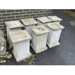 A set of seven square reconstituted stone garden plinths, width 35cm, height 55cm
