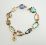 An early 20th century yellow metal and opal set bracelet, of various shapes and hung with central