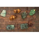 Five Chinese jadeite pendants and two wood lion-dog netsuke, netsuke 3.5 high