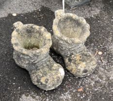 A pair of reconstituted stone garden planters modelled as boots, length 37cm, height 21cm