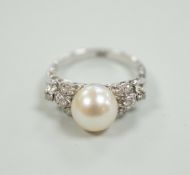 A 14k white metal and single stone cultured pearl set dress ring, with diamond cluster set