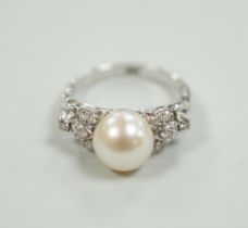 A 14k white metal and single stone cultured pearl set dress ring, with diamond cluster set