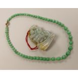 A Chinese jadeite carving and jadeite bead necklace, carving 6.5cm long
