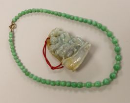 A Chinese jadeite carving and jadeite bead necklace, carving 6.5cm long