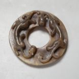 A Chinese brown and celadon jade ‘chilong’ bi disc, probably Ming dynasty, 8cm Provenance - the
