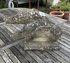 A reconstituted stone double greyhound head garden ornament, width 36cm, depth 23cm, height 28cm
