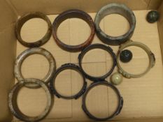 Nine assorted Chinese jade and hardstone bangles and three spheres, largest bangle 8.5cm diameter
