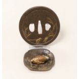 A gilt cast iron Japanese tsuba, gilt bronze ojime and pin dish