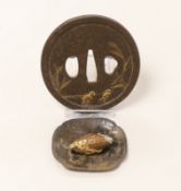 A gilt cast iron Japanese tsuba, gilt bronze ojime and pin dish