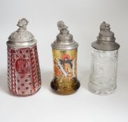 Three German glass steins including a Bohemian ruby flashed example, the largest 20cm high