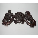 A 19th century carved figural door pediment, 46cm wide