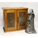 A German pewter commemorative flagon and an Art Nouveau smoker's cabinet,