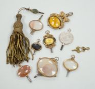 Ten assorted mainly 19th century base or yellow metal oval and gem set large watch keys, including