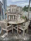 A circular weathered teak garden table with 'Lazy Susan' diameter 150cm, width 85cm, height 71cm and