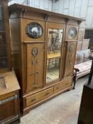 An Arts & Crafts copper and brass mounted oak compactum wardrobe in the style of Shapland &