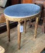 A George III style giltwood and composition oval dressing stool, width 50cm, depth 33cm, height