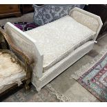 A French cream painted upholstered folding day bed, length 135cm, depth 68cm, height 77cm