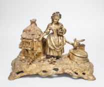 A 19th century gilt bronze inkwell decorated with a farmyard scene and country maiden, 18cm high