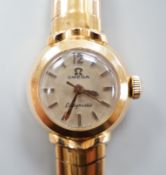 A lady's yellow metal, stamped 750, Omega Ladymatic wrist watch, on a 750 bracelet, length 17.cm,