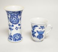 A Chinese blue and white small vase and a similar ‘Hundred Antiques’ chocolate cup, both Kangxi