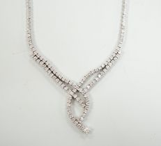 A modern 750 white metal and diamond set interwoven necklace, approx. 44cm, gross weight 28.1