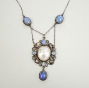 An Arts & Crafts white metal, mother of pearl and gem set drop pendant necklace, in the manner of