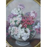 Alix Jennings (1884-1980), oil on board, Still life of flowers in a vase, oval, 50 x 44cm