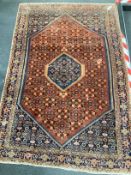 A North West Persian part silk red ground rug, 180 x 116cm