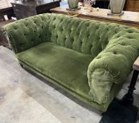 A late Victorian Chesterfield settee upholstered in buttoned green fabric, length 180cm, width 90cm,