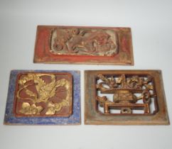 Three Chinese gilded and lacquered wood panels, early 20th century, longest 31cm