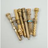 Six assorted late 19th/early 20th century yellow metal overlaid propelling pencils, including